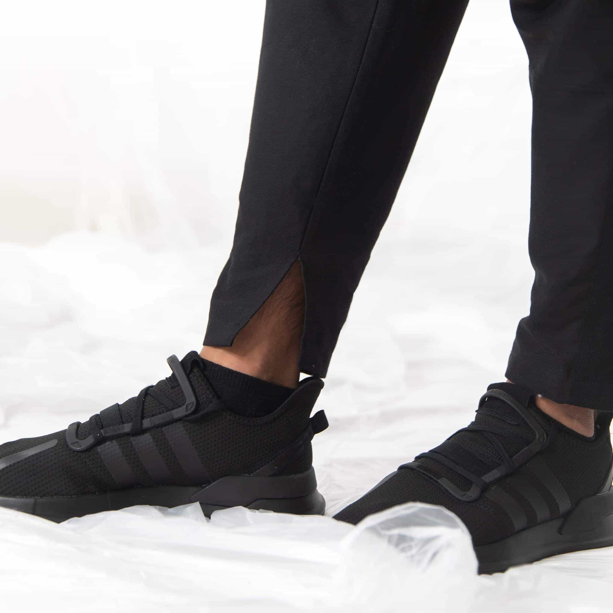   ZERØ London - alt. close up,  mens black zero waste trousers with gold d rings and contrast stripe designed & made in London