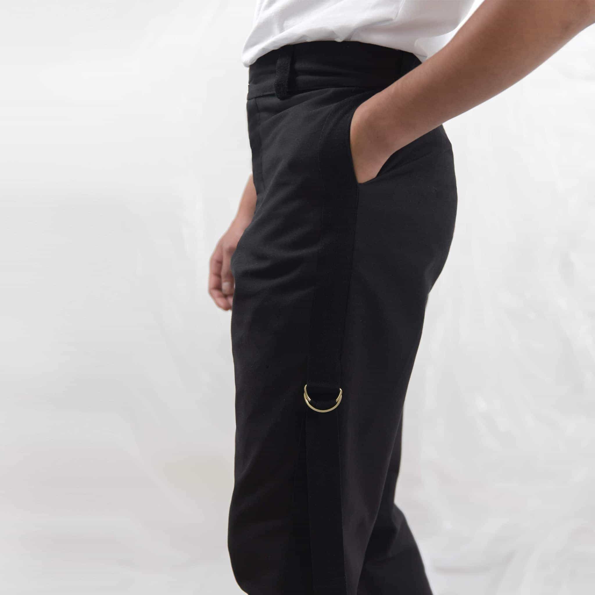   ZERØ London - Close up, mens black zero waste trousers with gold d rings and contrast stripe designed & made in London