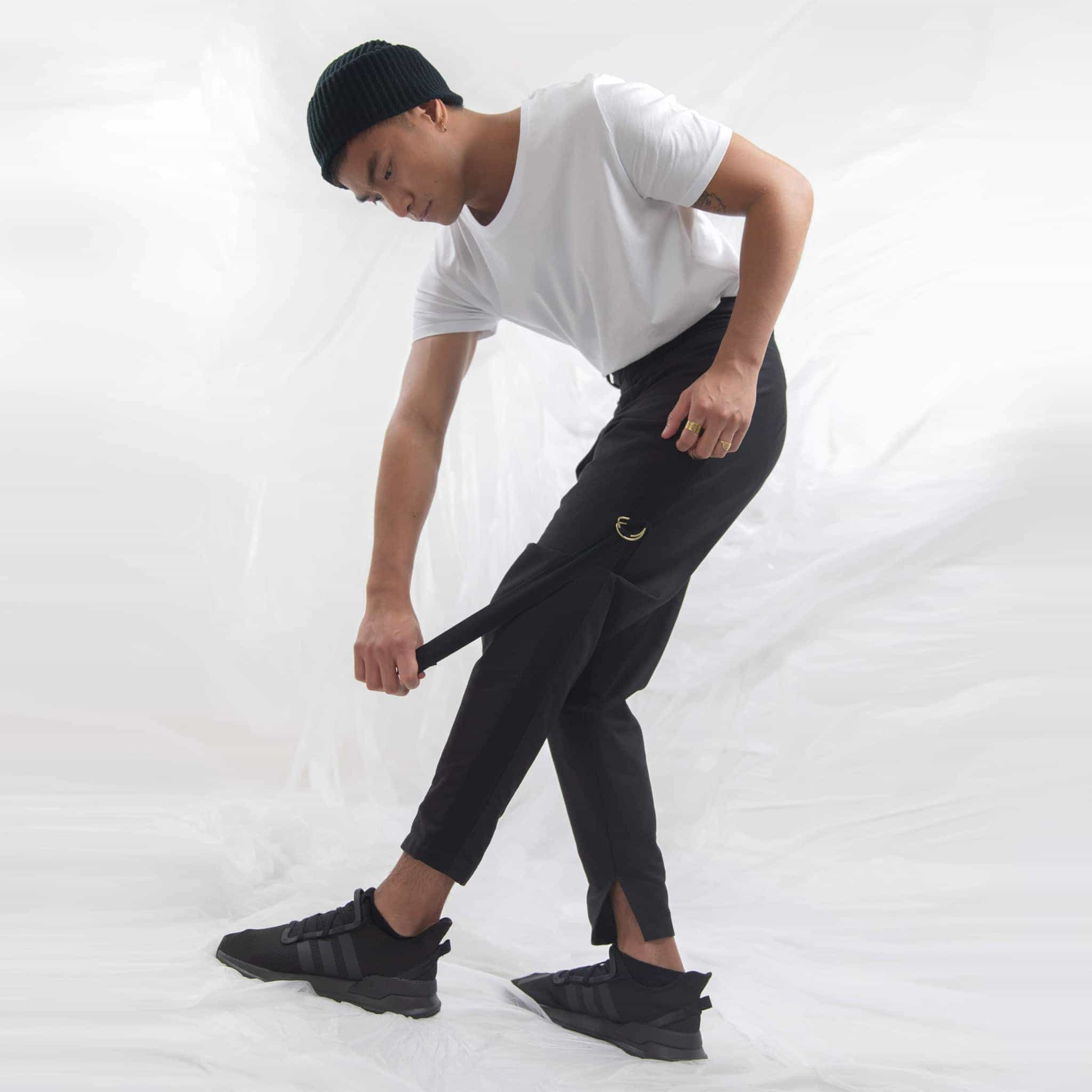   ZERØ London - Side alt. view,  mens black zero waste trousers with gold d rings and contrast stripe designed & made in London